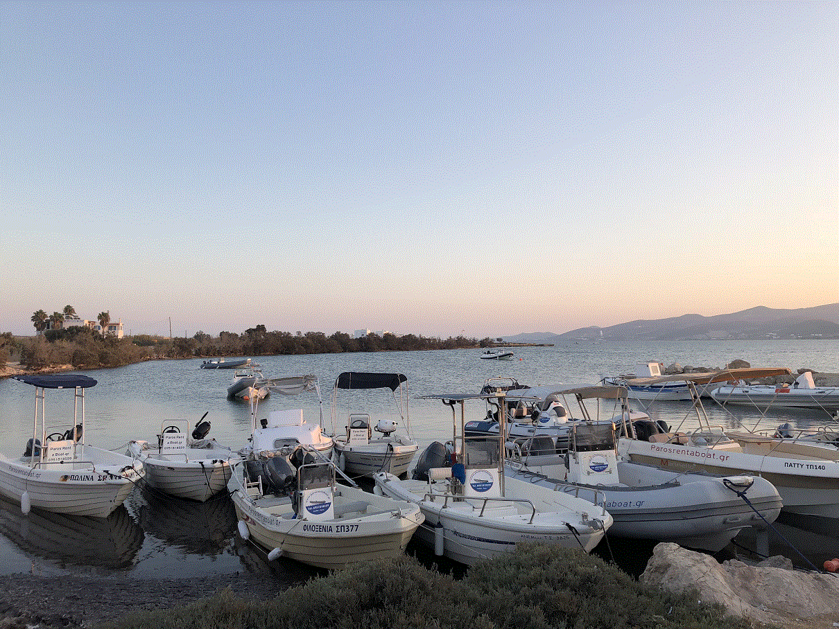 Paros Rent a Boat fleet moored at sunset in Pounta harbour, Paros